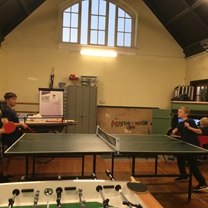 Two boys playing table tennis