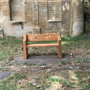 Handcrafted memorial bench, donated by a villager.