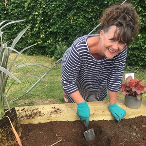 Planters at the crossroads - Cllr Sharron Comerford planting