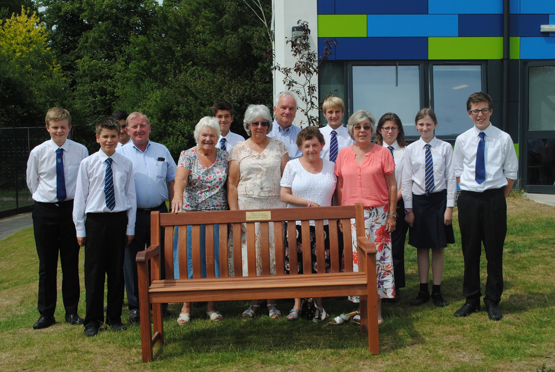Representatives from the Fundraising Committee present the garden seat to Perins school