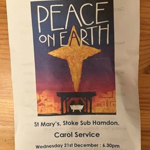 Poster for the carol service showing a gold star and the words Peace on Earth