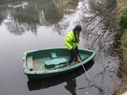 Clearing litter from the mill pond