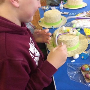 Boy making Easter bonnet at Youth Club