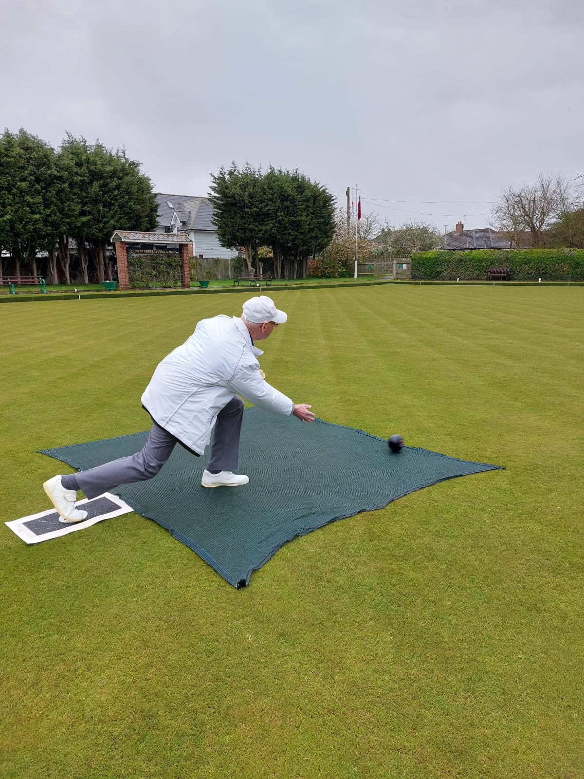 The Club President, Barrie Clements, bowls the first wood of the new season.