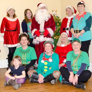 Parish Council staff and cllrs, in costume, with Father Christmas
