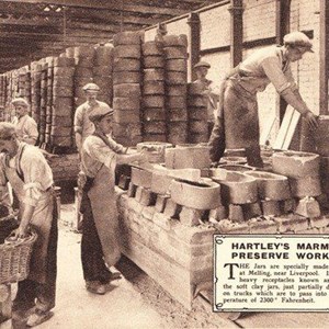 Loading: heavy receptacles known as 'saggers' containing soft clay in jars being loaded onto trucks which are passed onto kiln.