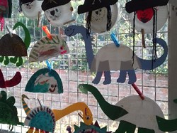 Dinosaurs and snowmen window display at Play Scheme
