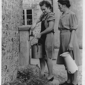 Girls collecting water from taps provided by Winchester College.