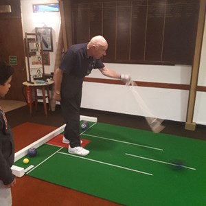 Mike Robins President of Daventry Town Bowling Club and Original Chairman of bowlsDAVENTRY showing Lewis how to use a bowling arm which allows Mike to keep on Bowling and competiting in a sport he has found in the last few years and loves playing